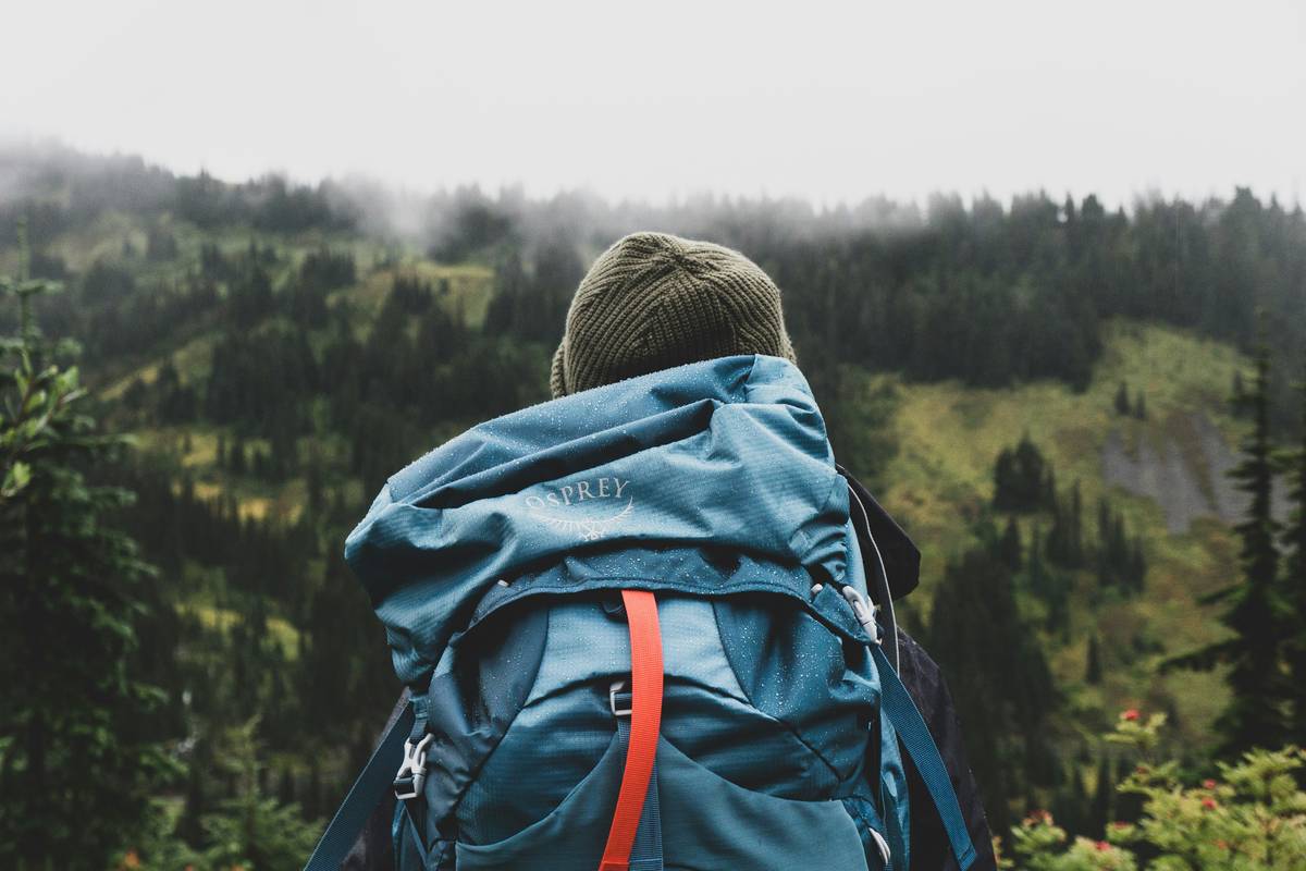 mountain climbing gear essentials including tricams, cams, and slings arranged on granite surface