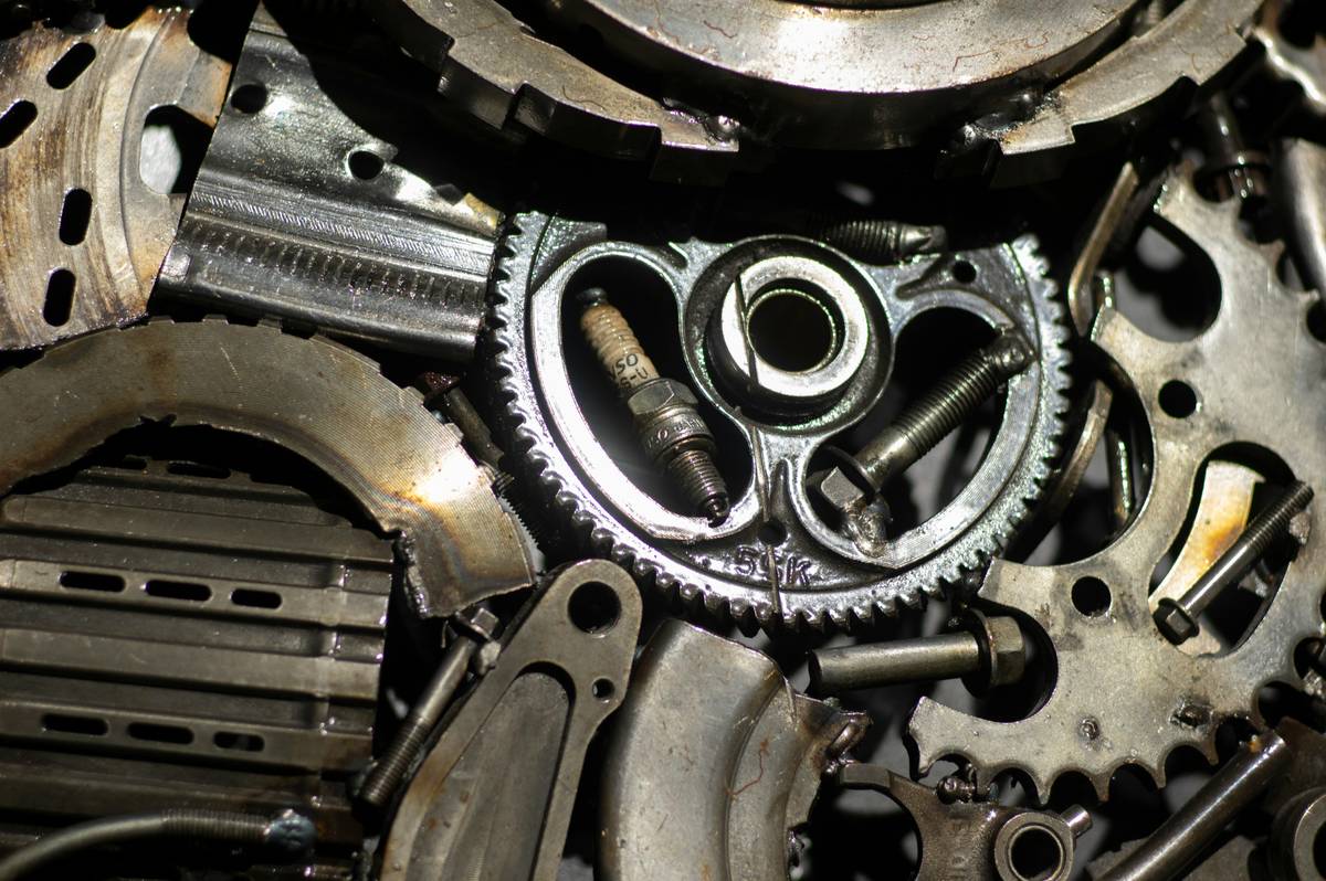 Close-up of worn climbing tricam showing metal fatigue and sling fraying, illustrating Triple Cam Material Options
