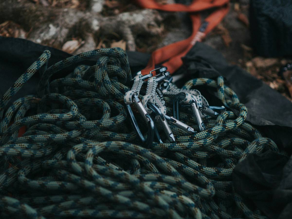 Climber demonstrating correct Triple Cam Placement Tips in a granite crack